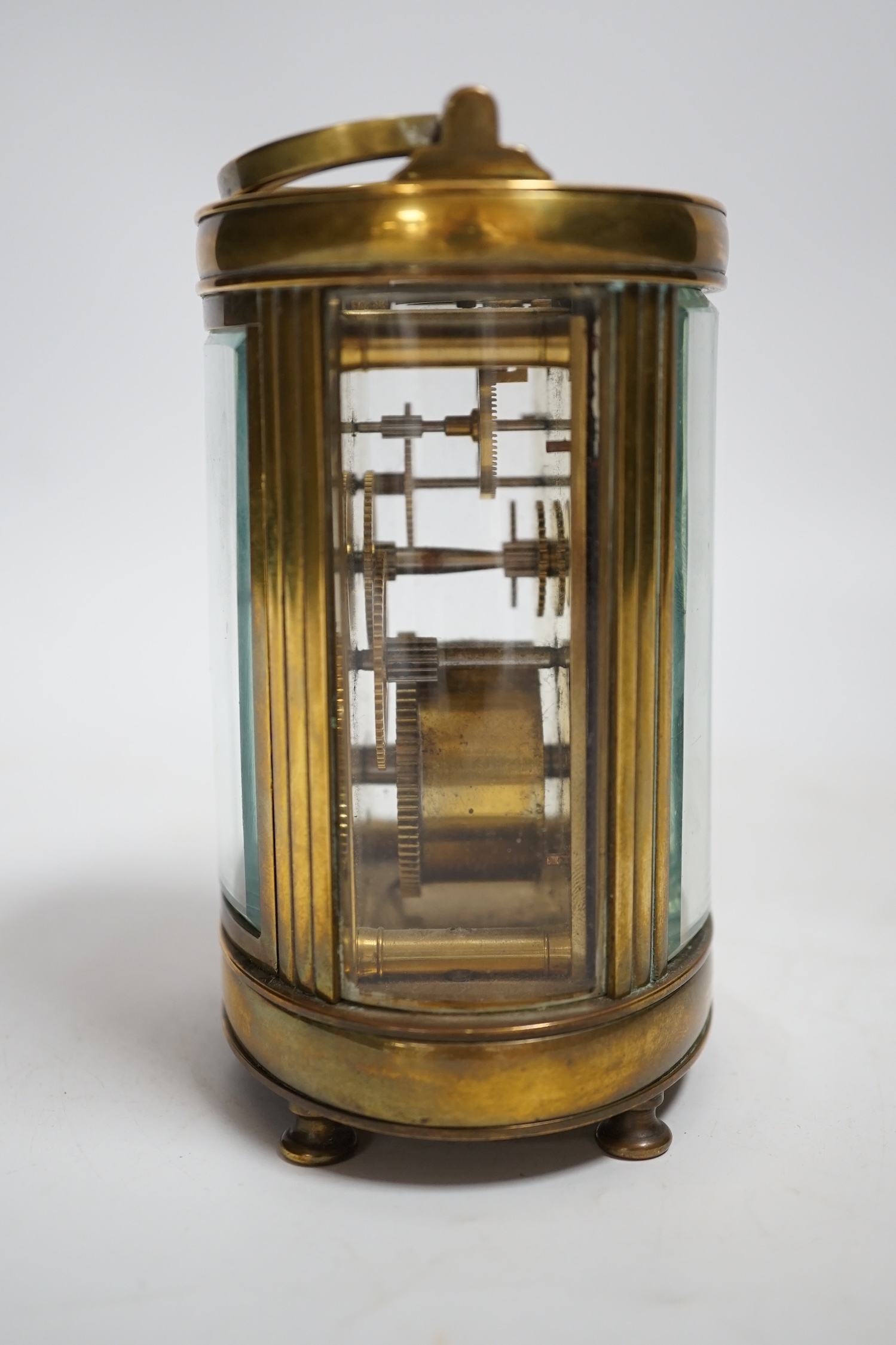 A brass oval cased carriage timepiece, stamped ‘Made in France’, 12cm